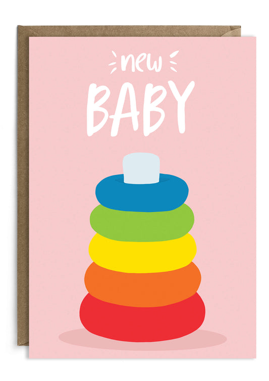 New baby card featuring a stacking toy on pink background